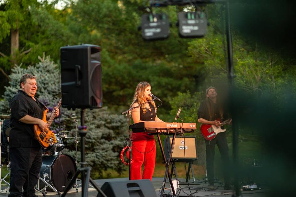 Izzy Joy and band performing on stage